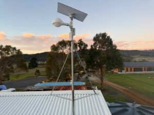 Starlink dish and outdoor WiFi 6 access point mounted on a guyed mast above a shed roof at Mapleton Vineyard, Tea Tree, Tasmania