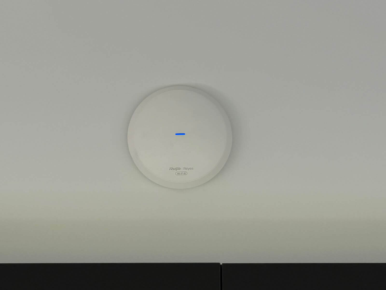 Close up of a Ruijie Reyee WiFi 6 ceiling mounted access point installed in a cellar door at Tea Tree, Tasmania