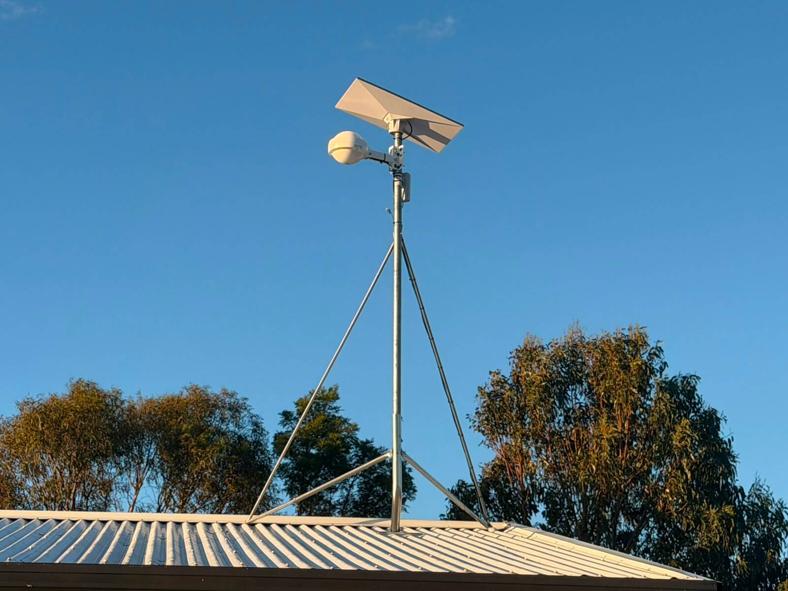 Starlink satellite dish and WiFi 6 outdoor access point on a guyed roof mast at a vineyard in Tea Tree, Tasmania
