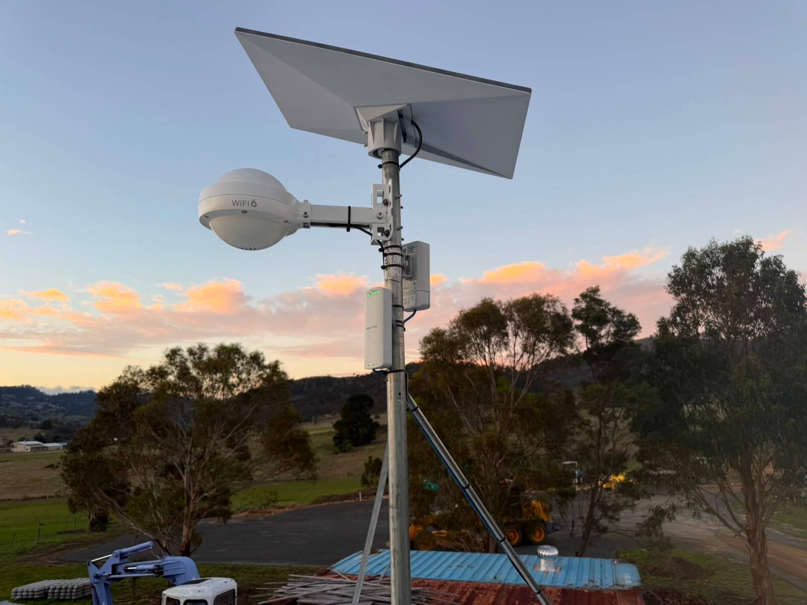 Starlink dish, outdoor WiFi 6 access point and power injector mounted together on a braced mast at Tea Tree, Tasmania
