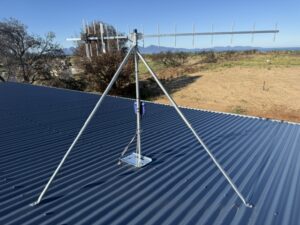 UHF TV antenna on a galvanised tripod mount on a roof in Dolphin Sands, Tasmania