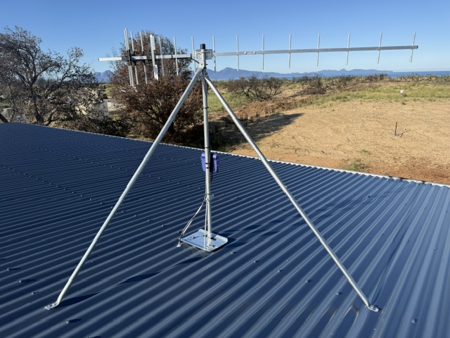 UHF TV antenna on a galvanised tripod mount on a roof in Dolphin Sands, Tasmania